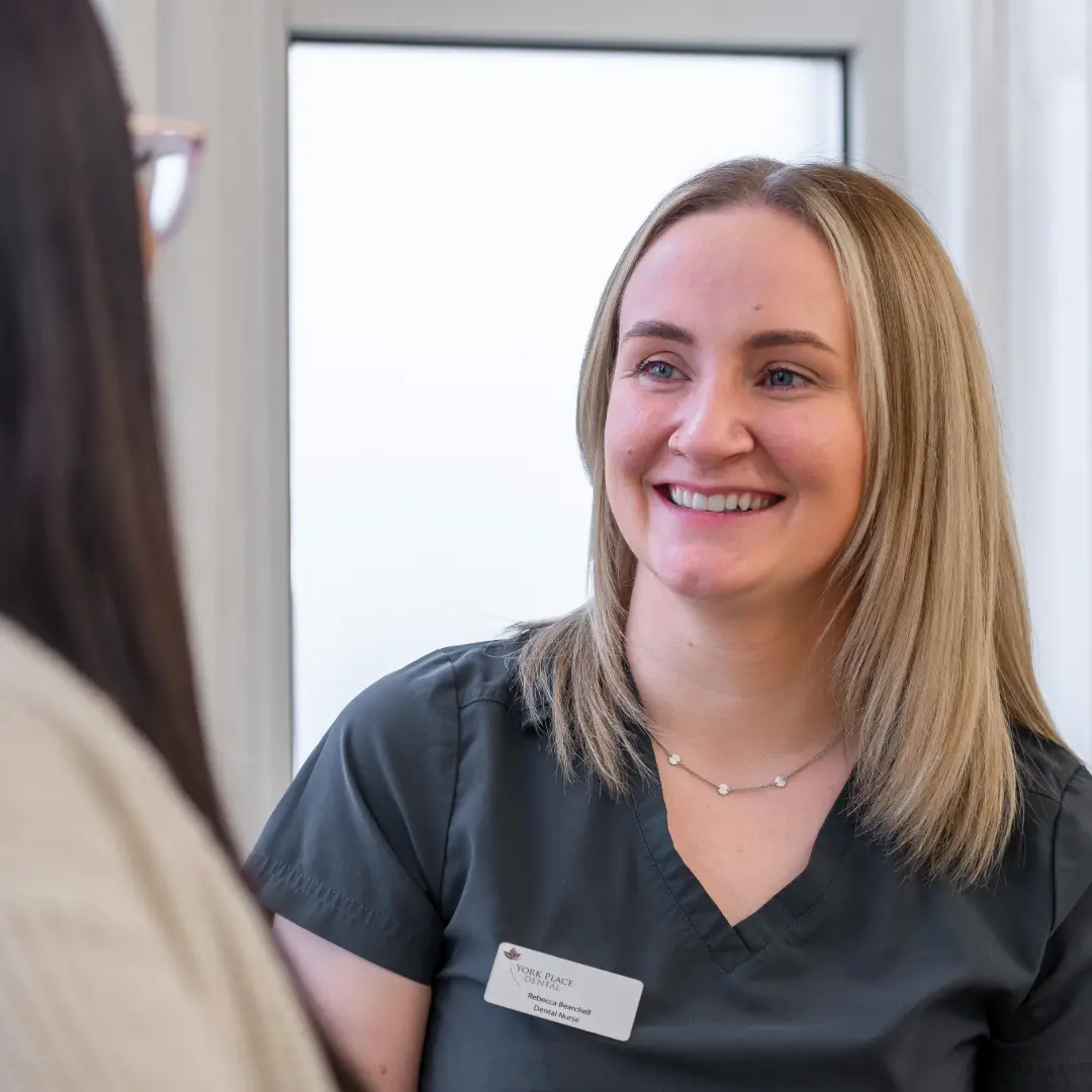 Friendly York Place Dental nurse speaking with a patient about personalised dental care in Carlisle.